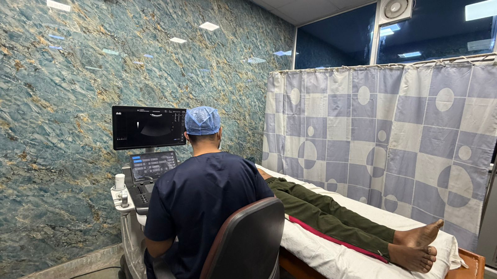 Medical staff using an ultrasound machine.
